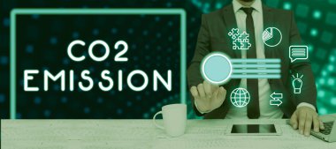 Text caption presenting Co2 Emission, Business showcase Releasing of greenhouse gases into the atmosphere over time Man With Laptop And Tablet Pointing On Power Button And Digital S.
