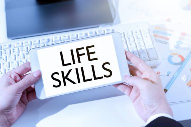 Text sign showing Life Skills, Internet Concept that is necessary or desirable full participation in everyday Woman Holding Notebook With New Ideas Over Desk With Computer And Keyboard.
