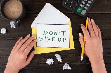 Text showing inspiration Don T Not Give Up, Business overview Determined Persevering Continue to Believe in Yourself Woman With Blank Letter, Coffee And Stationery Over Wooden Table.