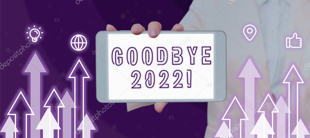 Writing displaying text Goodbye 2022, Concept meaning New Year Eve Milestone Last Month Celebration Transition Woman Showing Smartphone Between Graphical Arrows And Multiple S.