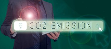 Sign displaying Co2 Emission, Business overview Releasing of greenhouse gases into the atmosphere over time Man With Pen Pointing On Digital Pin And Locating Direction On Map.