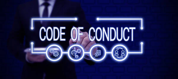 Conceptual caption Code Of Conduct, Business overview Ethics rules moral codes ethical principles values respect Businessman in suit holding open palm symbolizing successful teamwork.