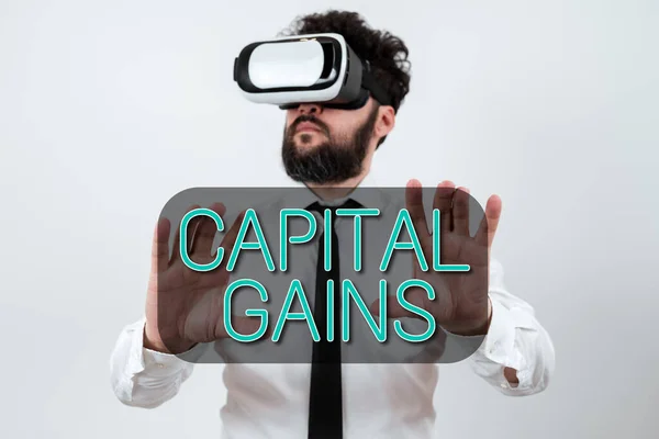 Conceptual caption Capital Gains, Business concept Bonds Shares Stocks Profit Income Tax Investment Funds Man Wearing Vr Glasses And Presenting Important Messages Between Hands.