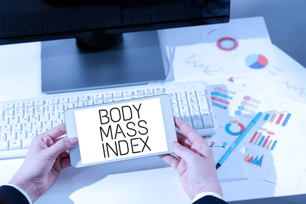 Handwriting text Body Mass Index, Business overview Value derived from the weight and height of an individual Woman Holding Notebook With New Ideas Over Desk With Computer And Keyboard.