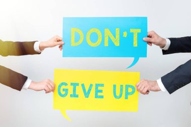 Writing displaying text Don T Not Give Up, Word for Determined Persevering Continue to Believe in Yourself Business Team Holding Two Important Ideas On Speech Bubbles On Both Sides.
