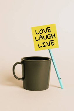Writing displaying text Love Laugh Live, Word Written on Be inspired positive enjoy your days laughing good humor Cup, Pen And Sticky Note With Important Announcement On Desk.