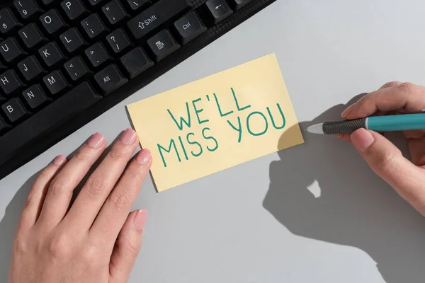 Writing displaying text We Ll Miss You, Conceptual photo Going to feel sad because you are leaving loving message Businesswoman Holding Note With Important Message On Office Desk.
