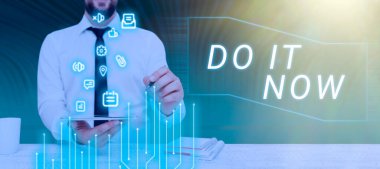 Conceptual caption Do It Now, Word Written on Respond Immediately Something needs to be done right away Businessman Holding Pen And Tablet With S And Presenting New Updates.