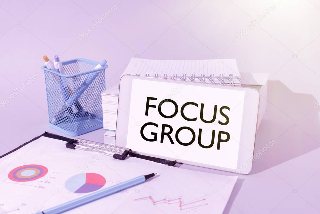 Handwriting text Focus Group, Business approach showing assembled to participate in discussion about something Important Idea Shown On Phone On Desk With Cup With Pencils And Books.