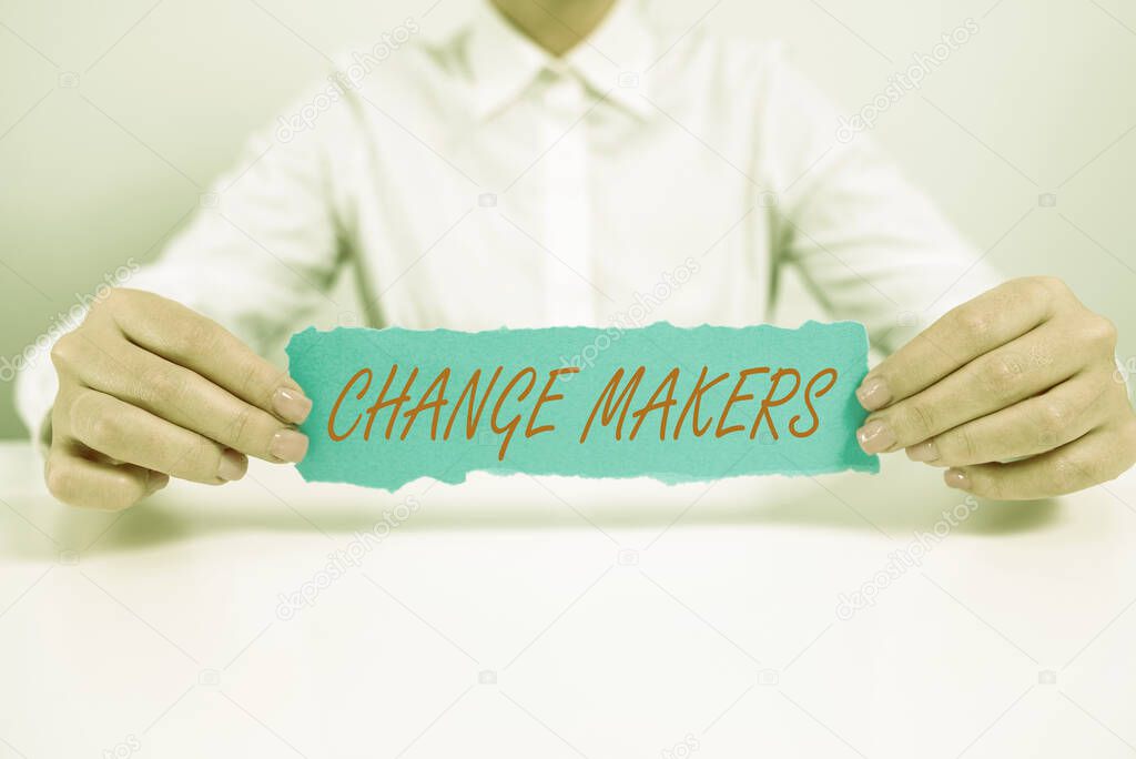 Text sign showing Change Makers, Internet Concept Young Turk Influencers Acitivists Urbanization Fashion Gen X Businesswoman Holding Note With Important Message On Office Desk.
