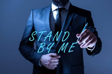 Handwriting text Stand By Me, Business approach Be always around myself there count on someone all the time Businessman Holding Pen And Presenting Important Informations.
