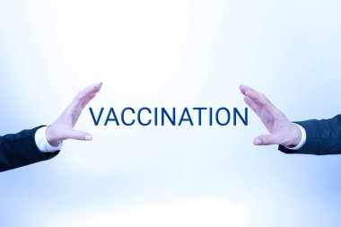 Inspiration showing sign Vaccination, Business approach Treatment which makes the body stronger against infection Important Information Presented Between Business Team Hands.