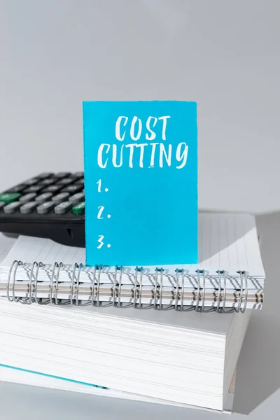 Text showing inspiration Cost Cutting, Conceptual photo Measures implemented to reduced expenses and improved profit Important Message Presented On Piece Of Paper On Desk With Keyboard.