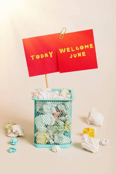 Hand writing sign Welcome June, Word Written on Calendar Sixth Month Second Quarter Thirty days Greetings Case Full Of Paper Wraps And Two Important Messages Pinned On Stick.