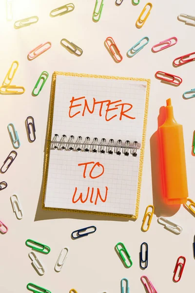 Handwriting text Enter To Win, Word Written on Sweepstakes Trying the luck to earn the big prize Lottery Important Message Written On Notebook With Colorful Paperclips Around.