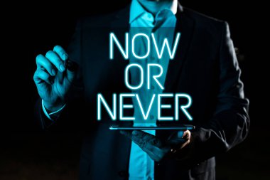 Text showing inspiration Now Or Never, Business showcase Do it in this precise moment or forget about it Motivation Hand With Pen Pointing Important Infortmations With Other Holding Tablet