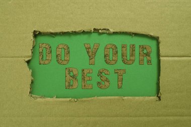 Conceptual caption Do Your Best, Word Written on Encouragement for a high effort to accomplish your goals Important Informations Written Underneath Ripped Cardboard.