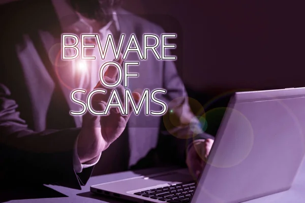 Hand writing sign Beware Of Scams, Business concept Stay alert to avoid fraud caution be always safe security Man Typing Important Data Into Laptop And Pointing New Idea With One Finger