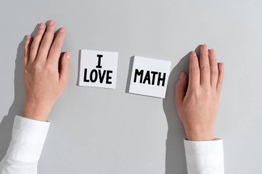 Writing displaying text I Love Math, Business showcase To like a lot doing calculations mathematics number geek person Businesswoman Presenting Different Informations On Two Notes.