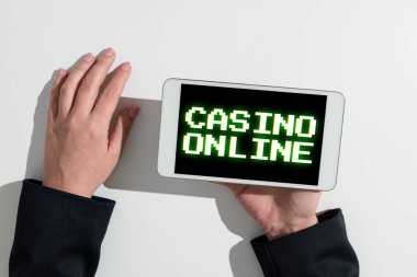 Text sign showing Casino Online, Word Written on Computer Poker Game Gamble Royal Bet Lotto High Stakes Businesswoman Holding Cellphone And Presenting Important Informations.