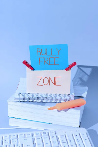 Inspiration showing sign Bully Free Zone, Word Written on Be respectful to other bullying is not allowed here Important Messages Presented On Piece Of Paper On Desk With Books.