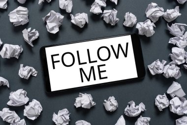 Text showing inspiration Follow Me, Conceptual photo Inviting a person or group to obey your prefered leadership Phone Screen With Important Message On It Surrounded With Paper Wraps.