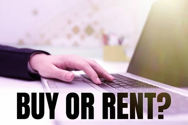 Writing displaying text Buy Or Rent, Word for Doubt between owning something get it for rented Indecision Businesswoman Typing Recent Updates On Lap Top Keyboard On Desk.