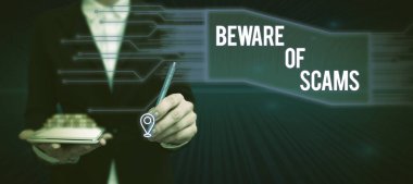 Sign displaying Beware Of Scams, Internet Concept Stay alert to avoid fraud caution be always safe security Lady in suit holding pen symbolizing successful teamwork accomplishments.