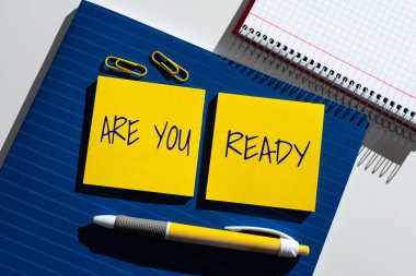 Sign displaying Are You Ready, Business concept Alertness Preparedness Urgency Game Start Hurry Wide awake Important News Presented On Two Sticky Notes On Desk With Notebook And Pen.