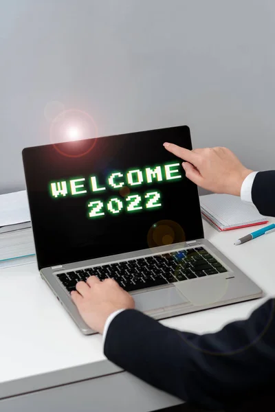 Writing displaying text Welcome 2022, Business showcase New Year Celebration Motivation to Start Cheers Congratulations Woman Typing Updates On Lap Top And Pointing New Ideas With One Finger.