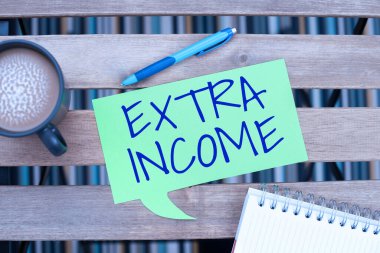 Sign displaying Extra Income, Business overview Additional fund received or earned from a non regular basis Speech Bubble With Important Announcement Placed On Table With Coffee.
