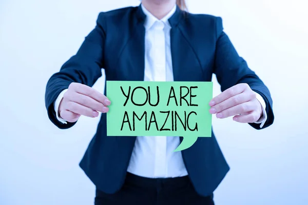 Text showing inspiration You Are Amazing, Business overview To have a great opinion about someone Admiration Wonder Lady in suit holding pen symbolizing successful teamwork accomplishments.
