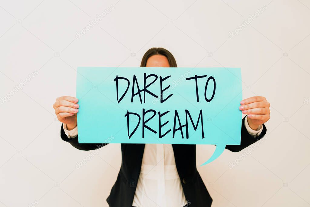 Inspiration showing sign Dare To Dream, Word for Do not be afraid of have great ambitions goals objectives Important Messages Presented On Piece Of Paper On Desk With Books.