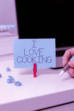 Conceptual caption I Love Cooking, Business approach Having affection for culinary arts prepare foods and desserts Businessman in suit holding open palm symbolizing successful teamwork.