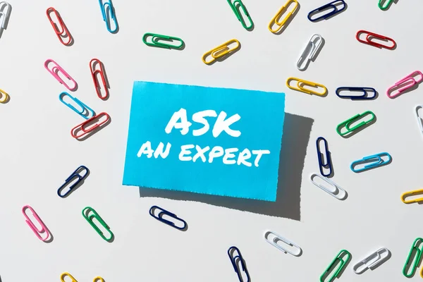 Handwriting text Ask An Expert, Business showcase Asking for advice to someone with great knowledge in a subject Businesswoman Holding Mobile Phone With Important Messages Sitting On Desk.