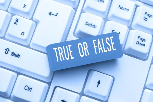 Hand writing sign True Or False, Internet Concept Decide between a fact or telling a lie Doubt confusion Important Messages Presented On Mobile Phone Leaning On Books And Notebook.
