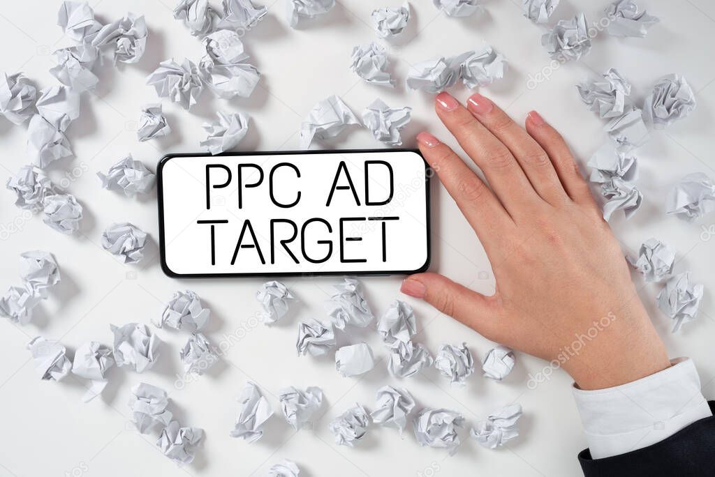 Writing displaying text Ppc Ad Target, Business concept Pay per click advertising marketing strategies online campaign Hand Holding Mobile Phone Pressing Application Button Showing Technology.