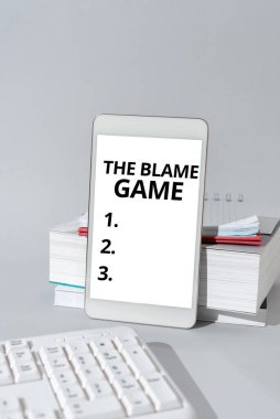 İlham kaynağı gösteren bir metin İnsanların birbirlerini suçlamaya çalıştıkları GameA durumu, Kavramsal fotoğraf Bir başkasının elinde kalem ve tablet tutan bir adamı suçlamaya çalışırken ortaya çıkan durum
