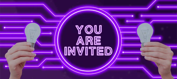 Sign displaying You Are Invited, Business concept Receiving and invitation for an event Join us to celebrate Businessman Holding Futuristic Design Over Hands And Showing New Data.