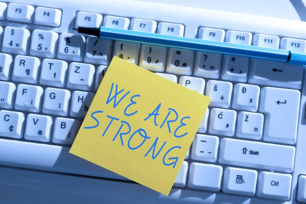 Hand writing sign We Are Strong, Business showcase Have great strength healthy powerful achieving everything