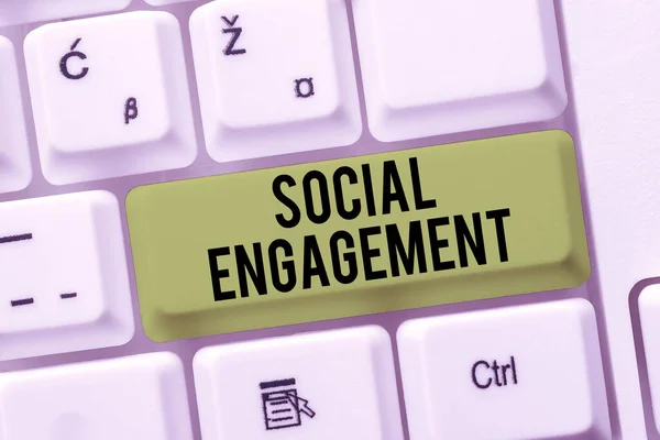 Hand writing sign Social EngagementDegree of engagement in an online community or society, Internet Concept Degree of engagement in an online community or society