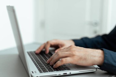 Businesswoman Typing Recent Updates On Lap Top Keyboard On Desk.