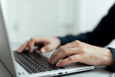 Businesswoman Typing Recent Updates On Lap Top Keyboard On Desk.