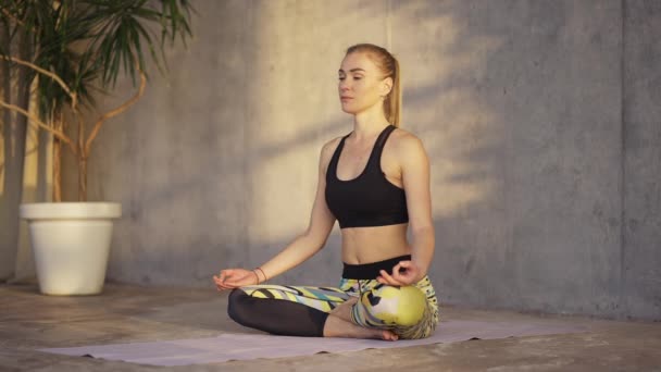 Blonde woman doing breathing practices in the studio — стоковое видео