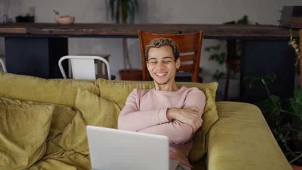 Happy young man laughing talking to friends on video conference or watch the show — Stockvideo