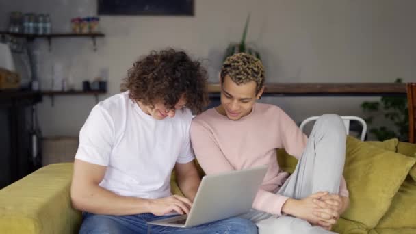 Two male gay couple using laptop computer for video calling or surfing internet — Stok video