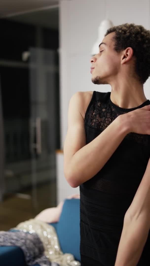 A man in little black dress sensually moves and touching himself — Stock Video