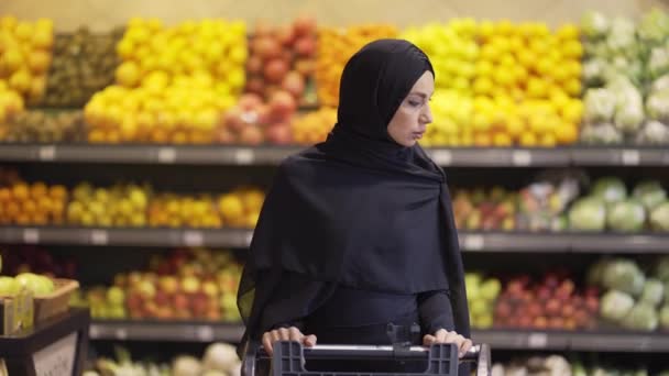 Портрет мусульманки, покупающей продукты в супермаркете — стоковое видео