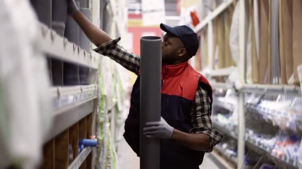 Πωλητής στέκεται σε hypermarket νοικοκυριού, τακτοποίηση προϊόντων - σωλήνες, σωλήνες — Αρχείο Βίντεο