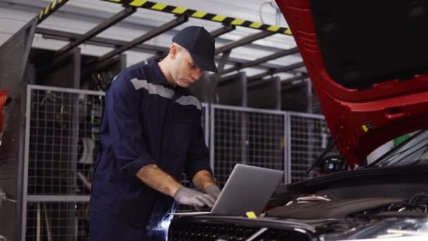 Auto mecânico usa um laptop durante a realização de teste de diagnóstico — Vídeo de Stock